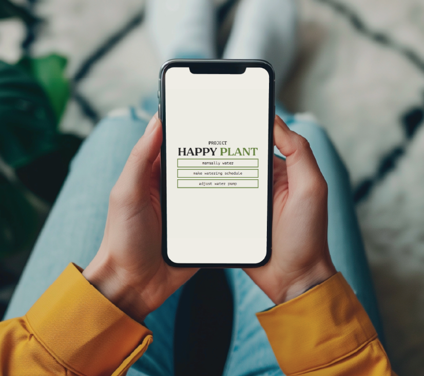 Hands holding a phone showing the Project Happy Plant app with manual water and scheduling options.