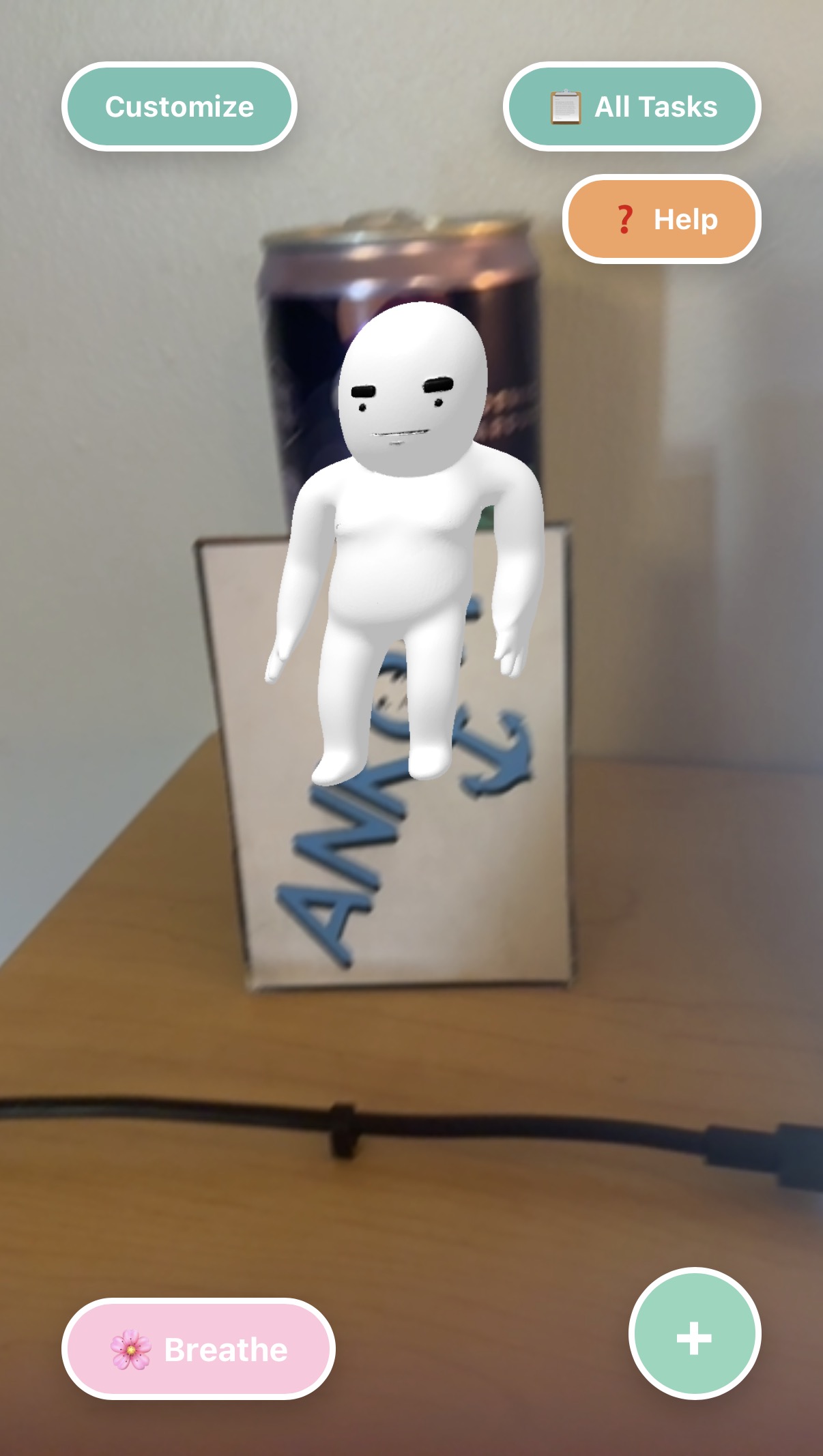 AR home view: the white Ankor mascot stands on a cardboard box labeled Ankor on a desk.