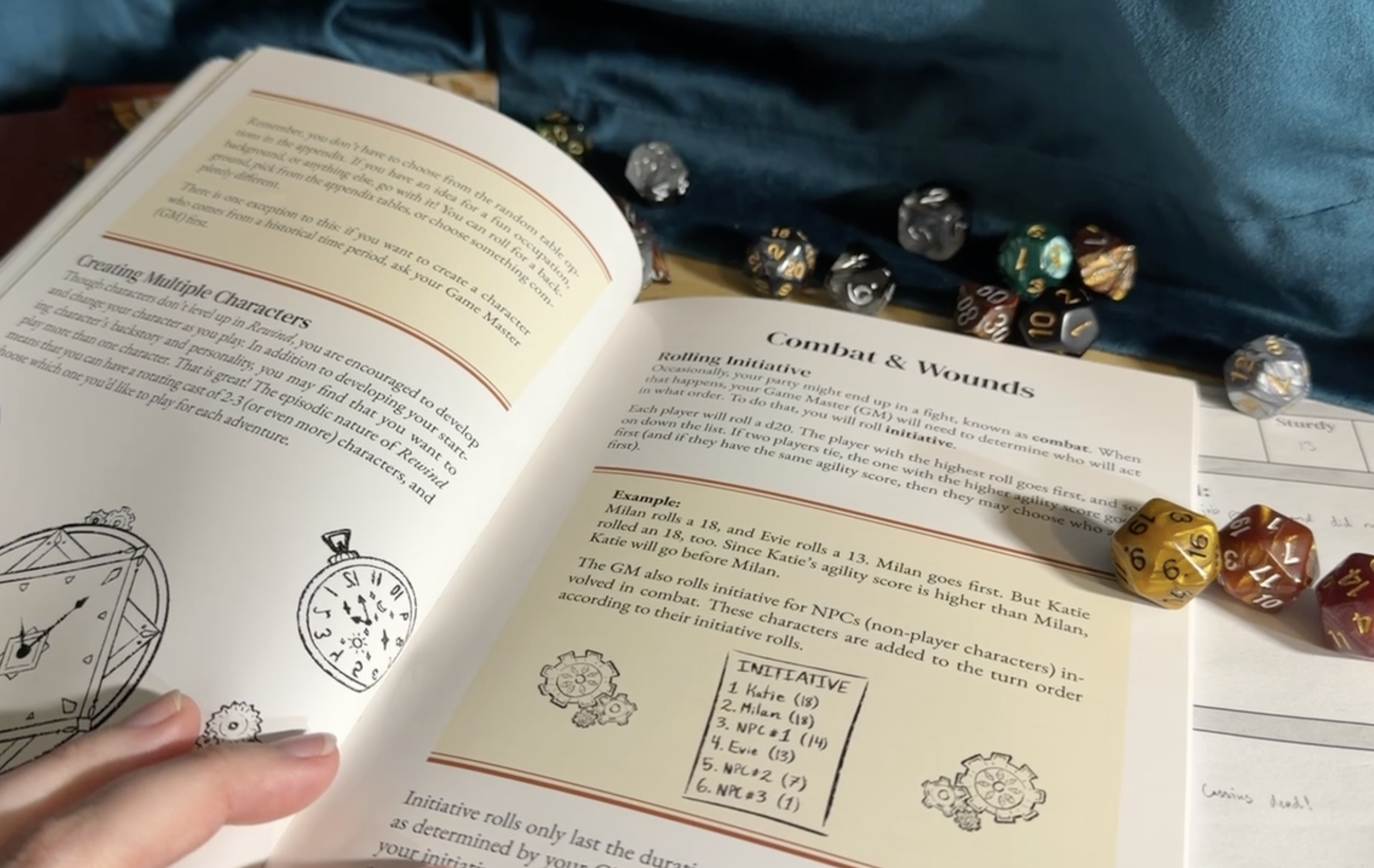 Open Rewind rulebook to the Combat and Wounds page, with polyhedral dice resting on the pages.