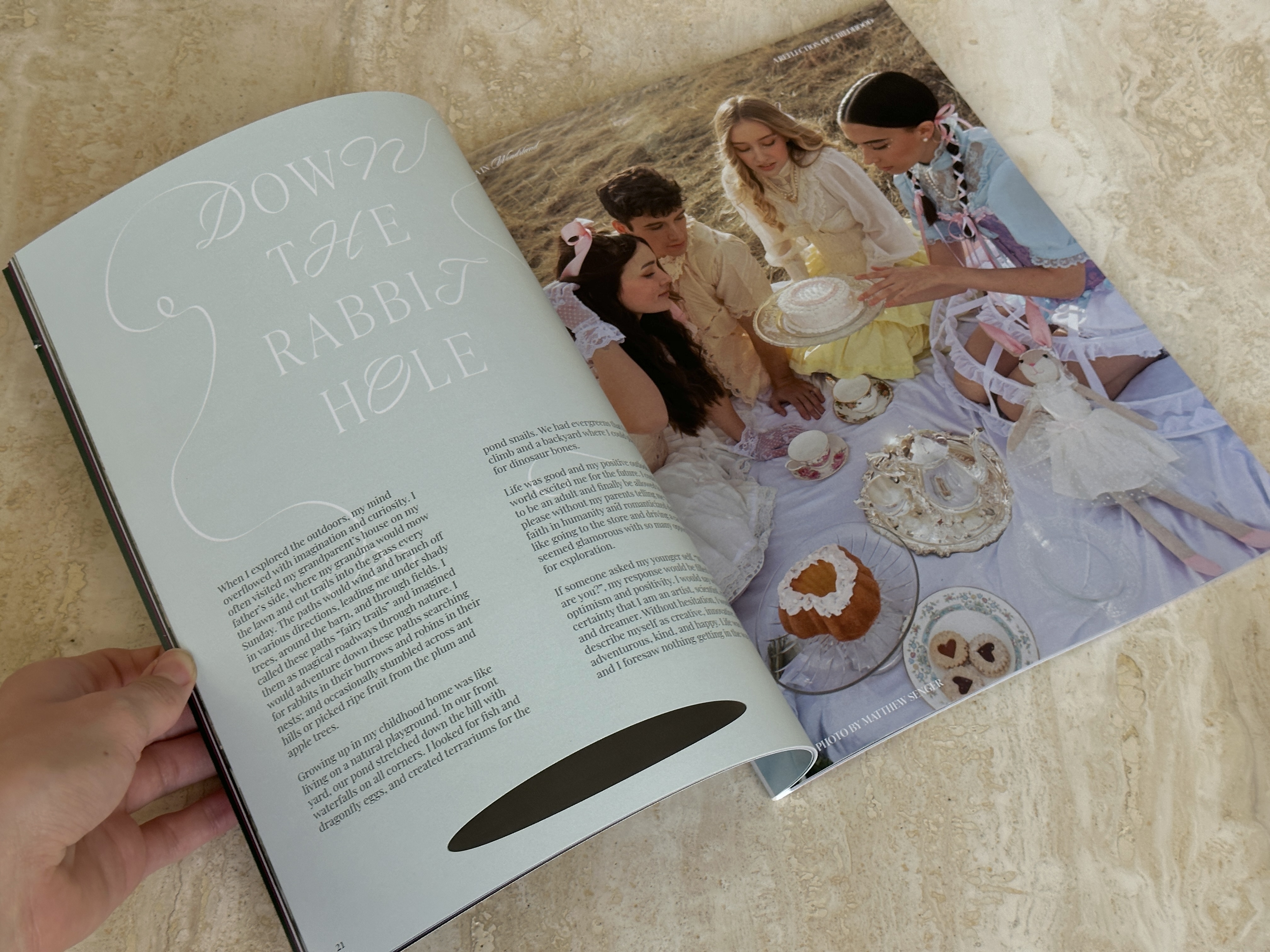 Magazine spread titled Down the Rabbit Hole; teens in pastel dresses at a styled picnic.