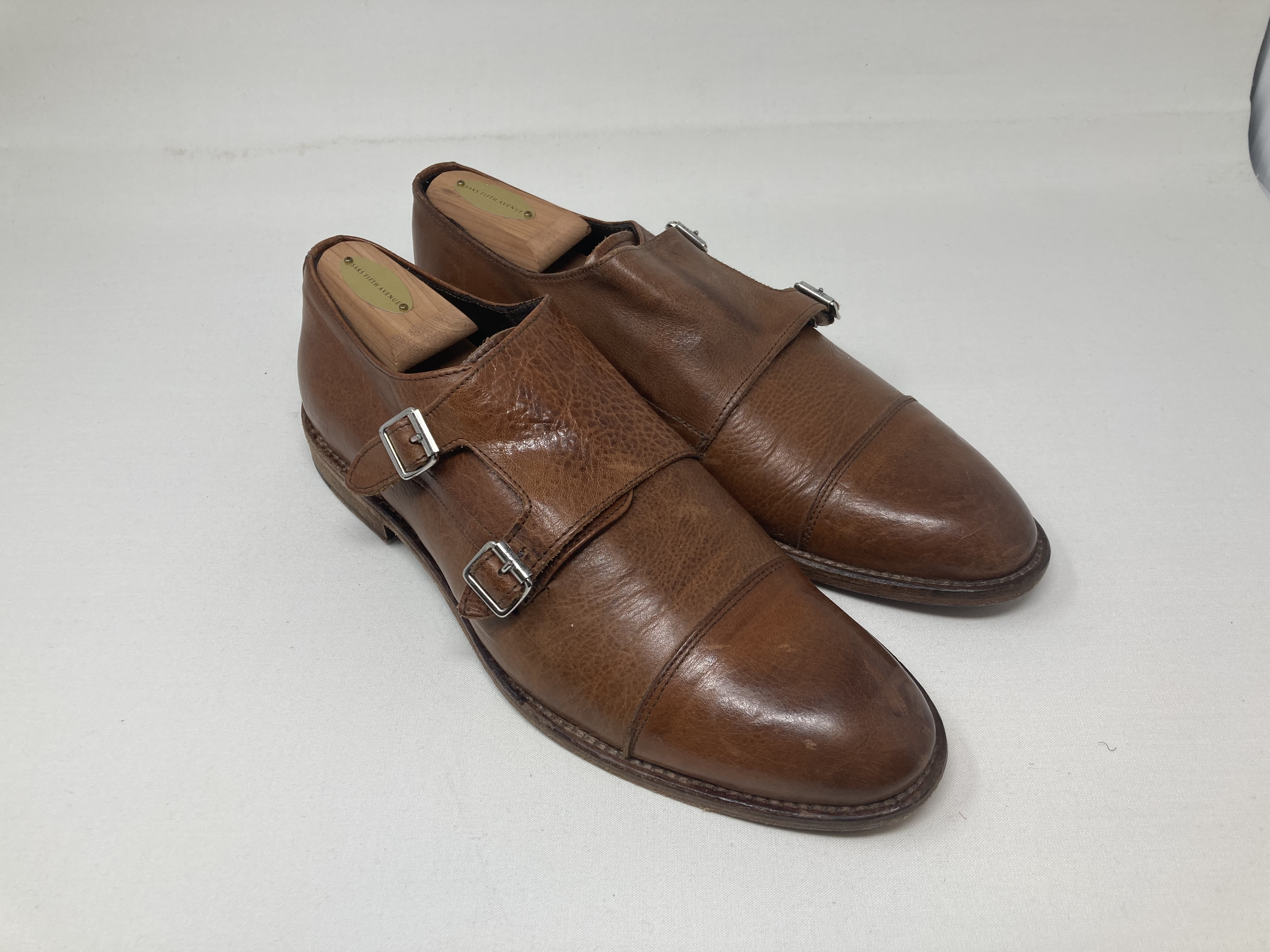 Brown leather double monk-strap shoes with silver buckles and cap toes, with shoe trees.