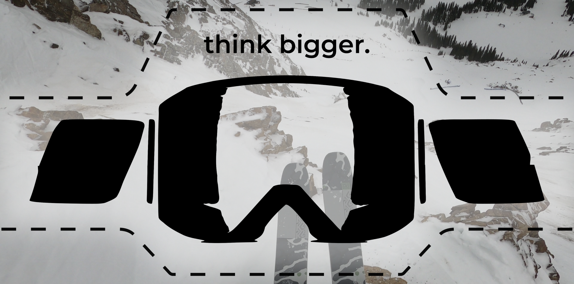 Snowy mountain photo with 'think bigger.' and a black ski-goggle silhouette outlined in dashes.