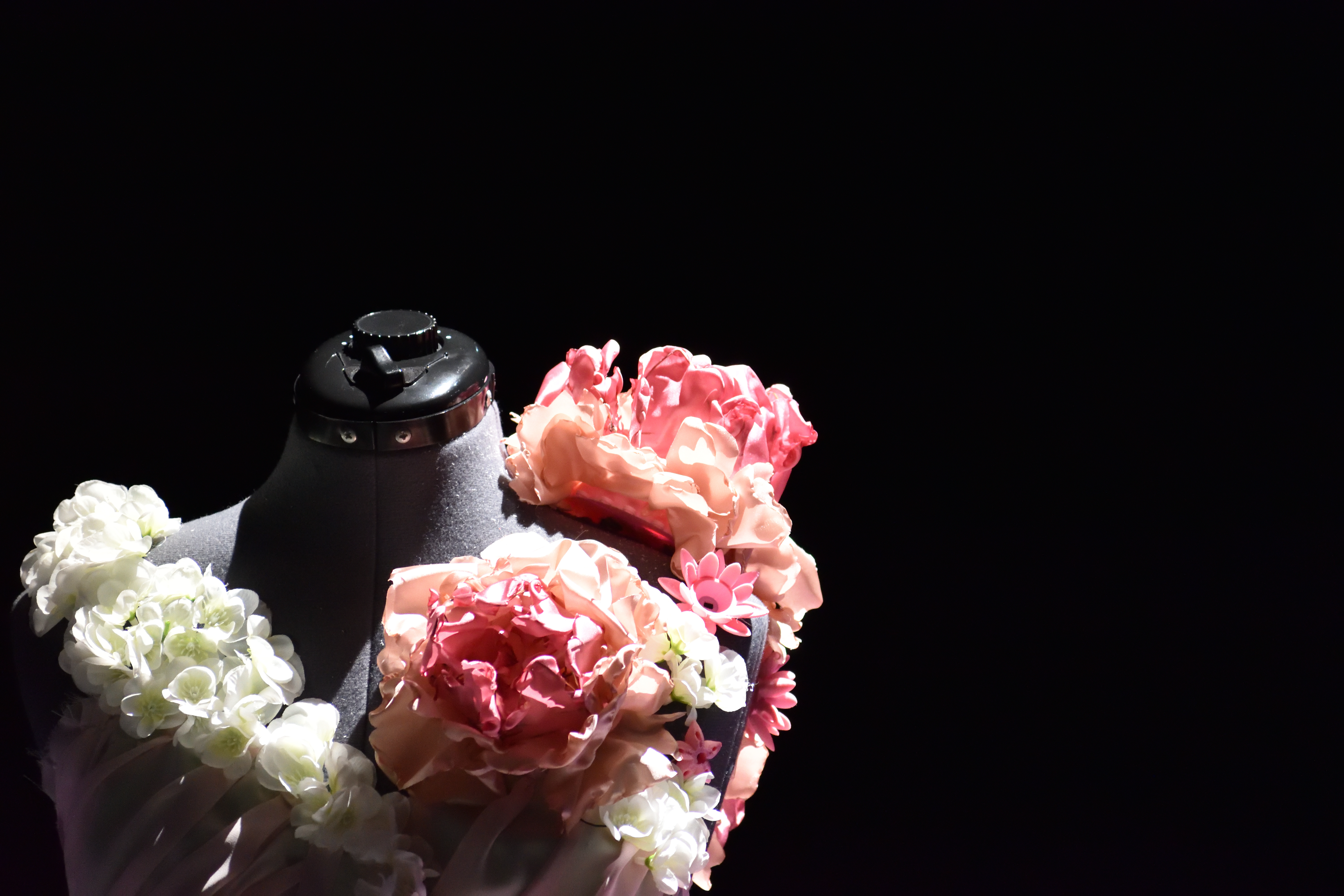 Detail of the gown's shoulder with white hydrangeas and pink and peach fabric peonies.